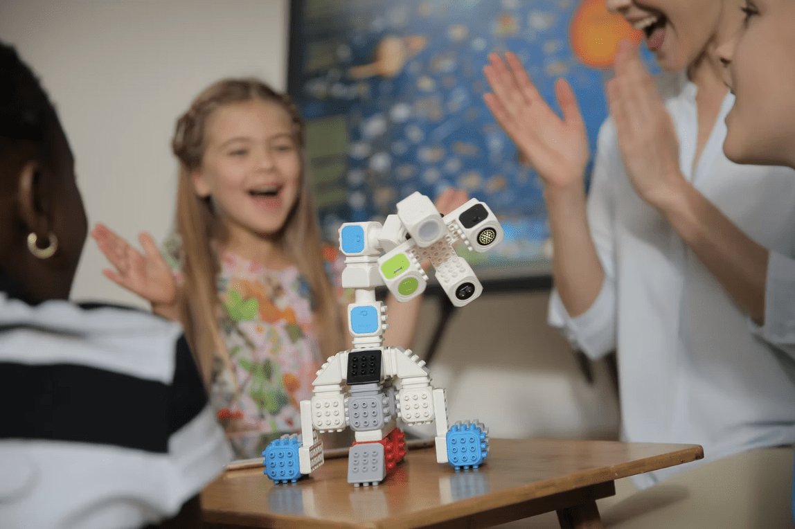Children playing with a Cubroid drum robot