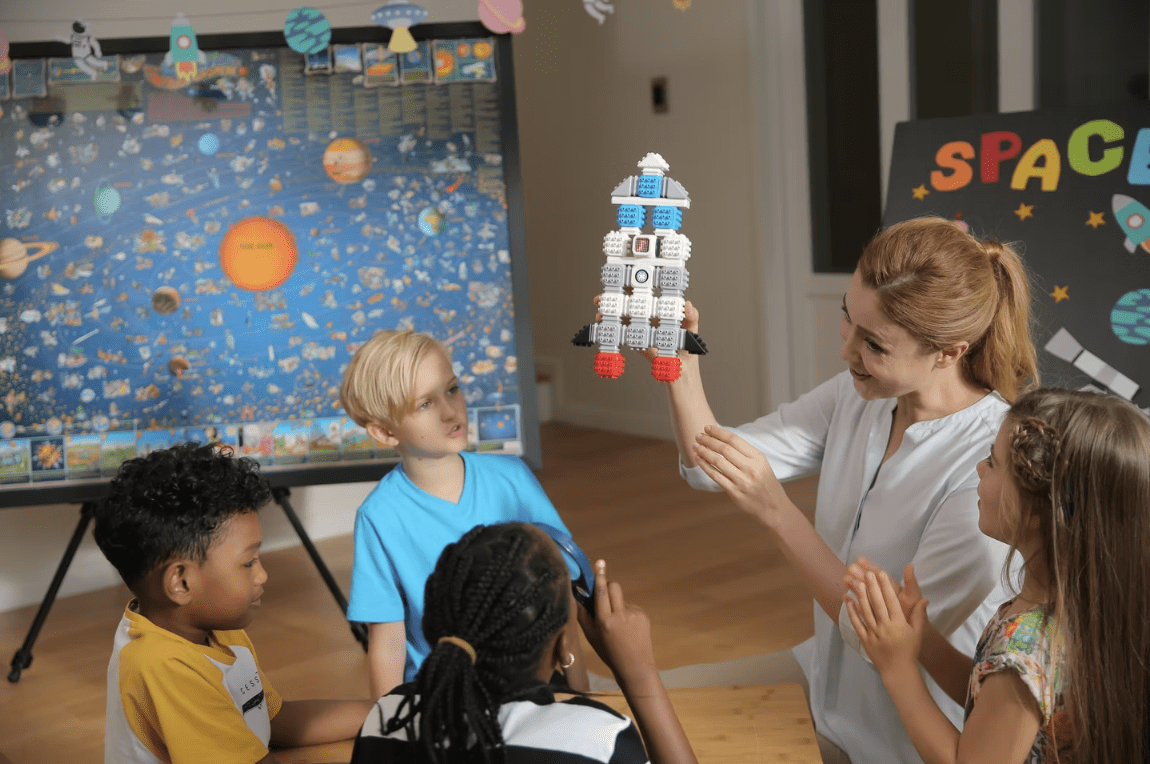 Children building Cubroid robots together in a classroom