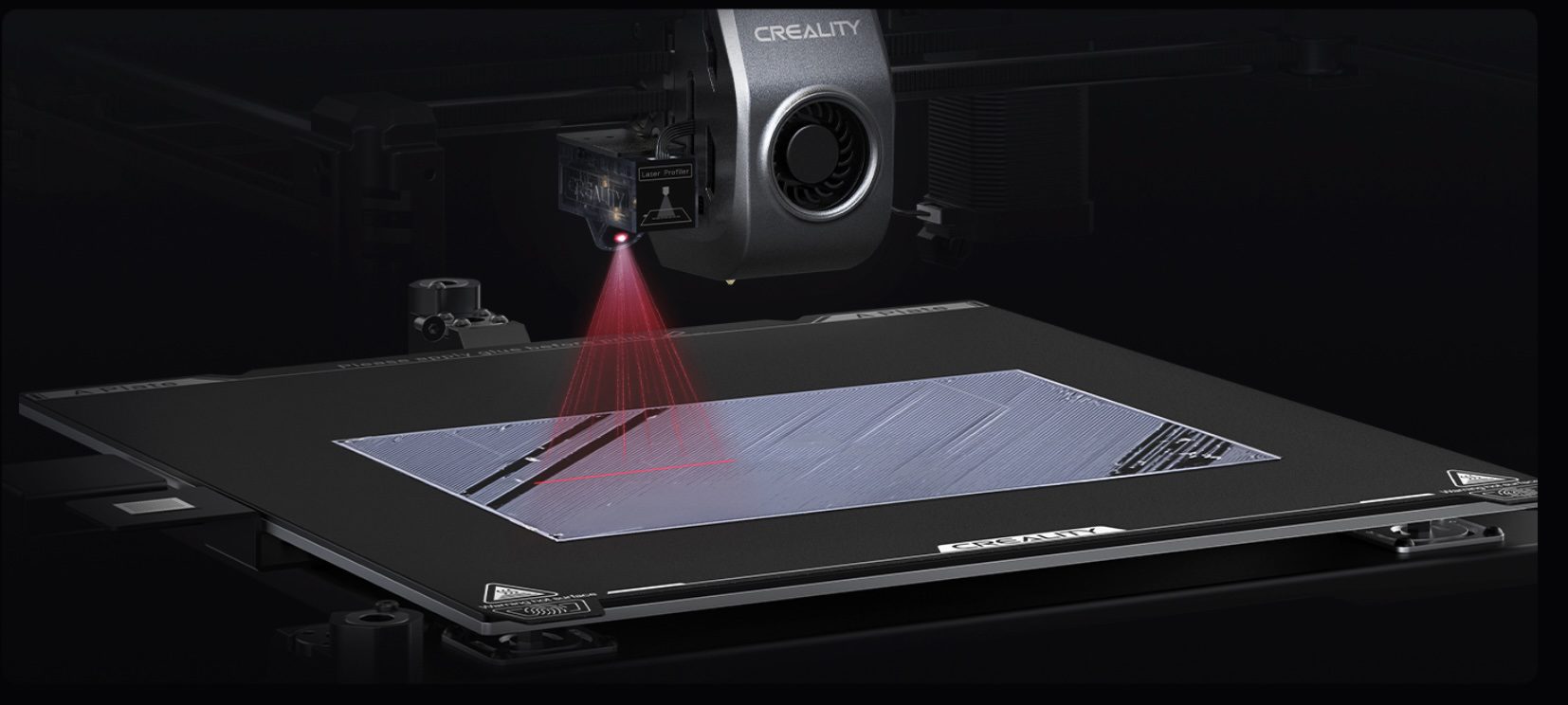 Two Creality K1 Max 3D printers side by side on a dark studio background, actively printing